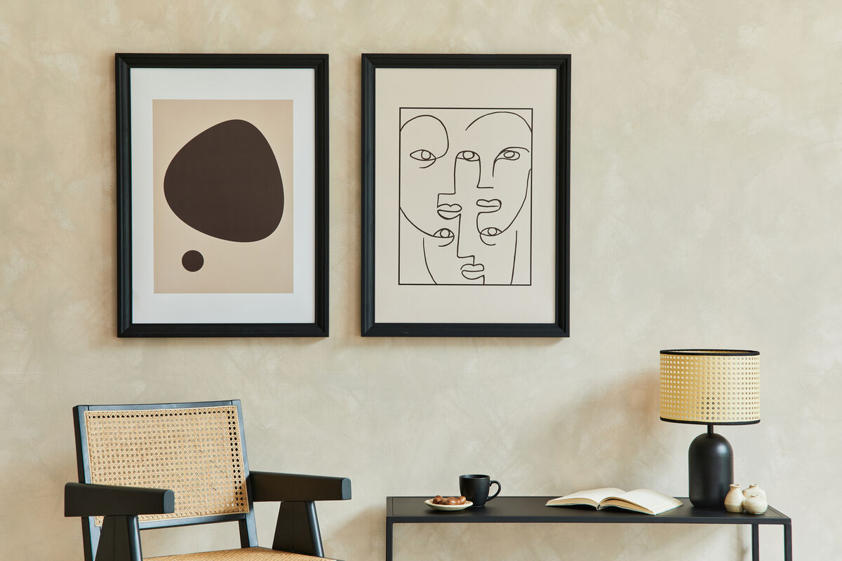 Pair of Gallery Black Hardwood frames displaying abstract and line-drawing prints in a minimalist living room